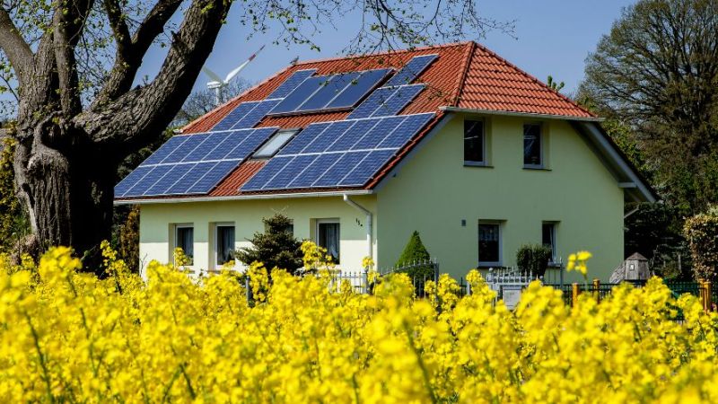 Symbolic photo: old building with photovoltaic system