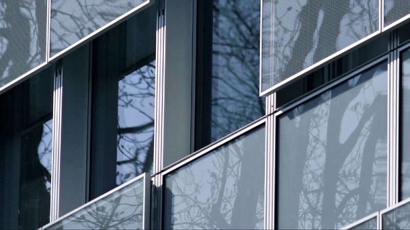 Detail of the new facade with movable parapet elements made of glass expanded metal as sun protection.