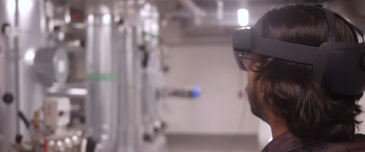 Here, a person is using augmented reality in a technical room with the help of special glasses. This makes it possible, for example, to compare discrepancies between the digital model and the actual situation on the construction site.