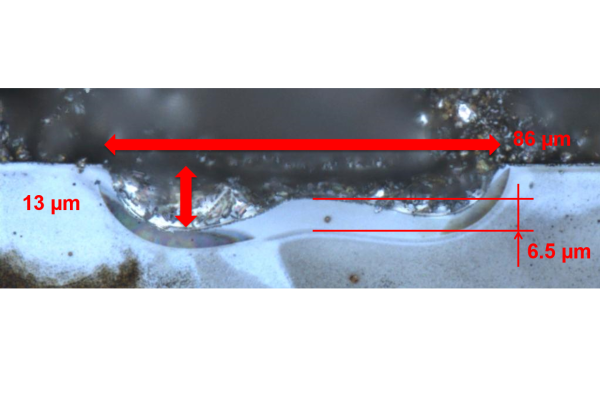 The optical microscope image shows the cross-section of a local emitter area formed by aluminium paste. The lateral diffusion of silicon is reduced during the melting phase. This results in the formation of a deeper emitter region during the recrystallisation phase.